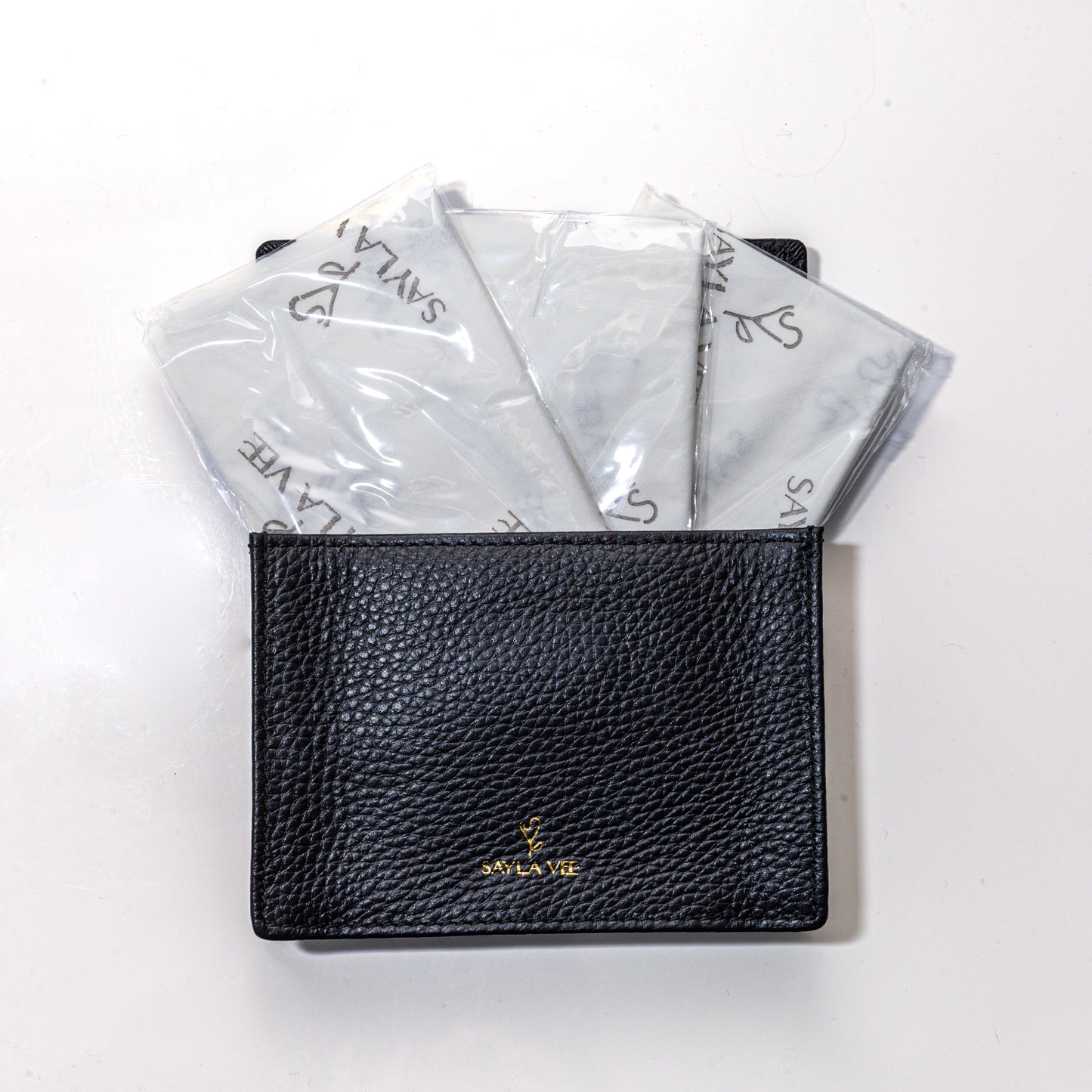 Travel-size full-grain leather wallet with magnetic closure to hold sayla vee flushable toilet seat cover wallet and plant-based wipes