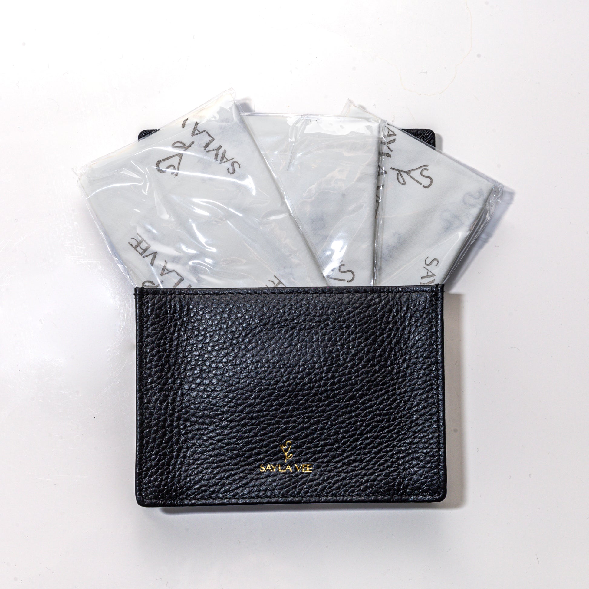 Travel-size full-grain leather wallet with magnetic closure to hold sayla vee flushable toilet seat cover wallet and plant-based wipes